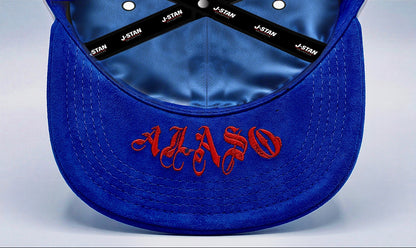 White and blue cap with various designs and text on a light gray background